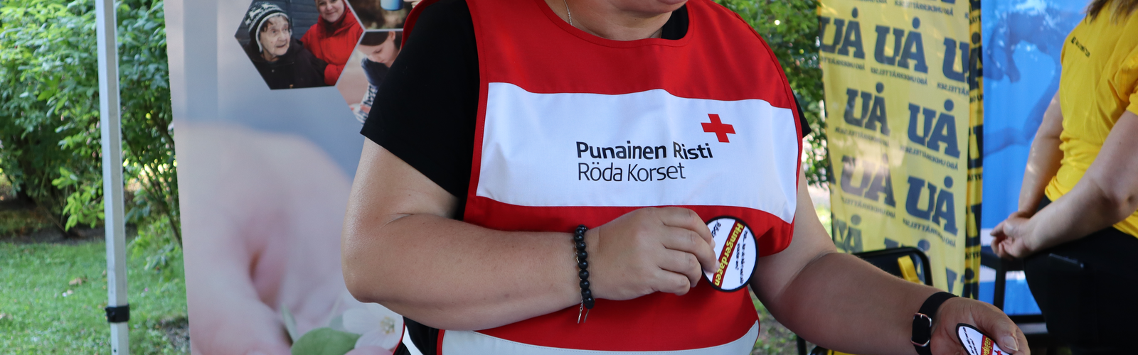 En person med Röda Korset väst på en sommar händelse.